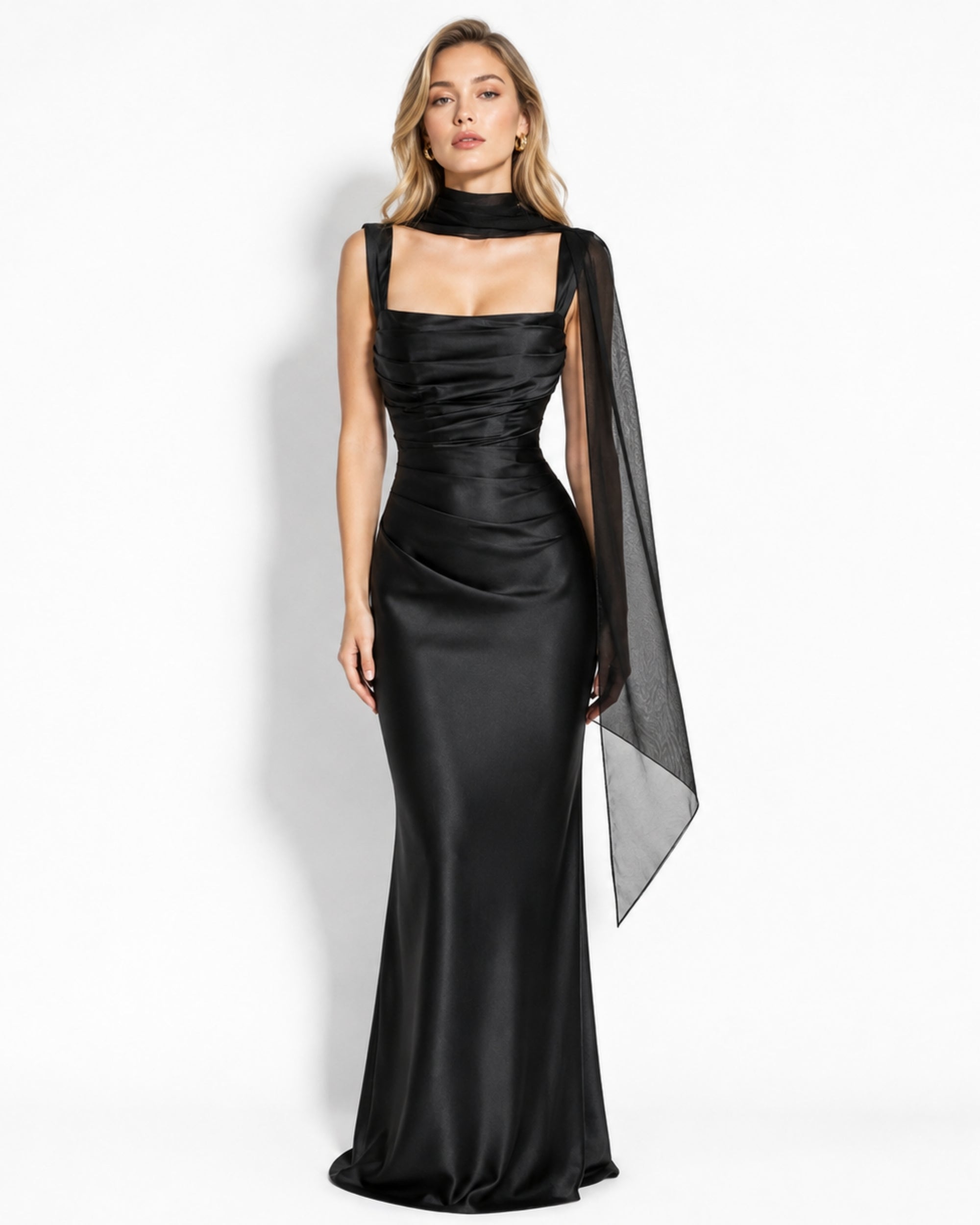 Woman wearing a black luxury satin corset evening gown with square neckline and sheer scarf accessory.