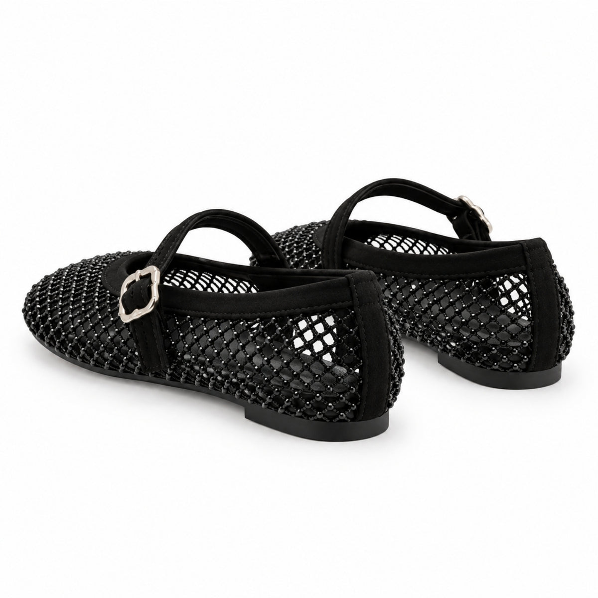 A pair of black open-mesh ballet flats with black straps and silver-tone buckle details, shown on a plain white background.