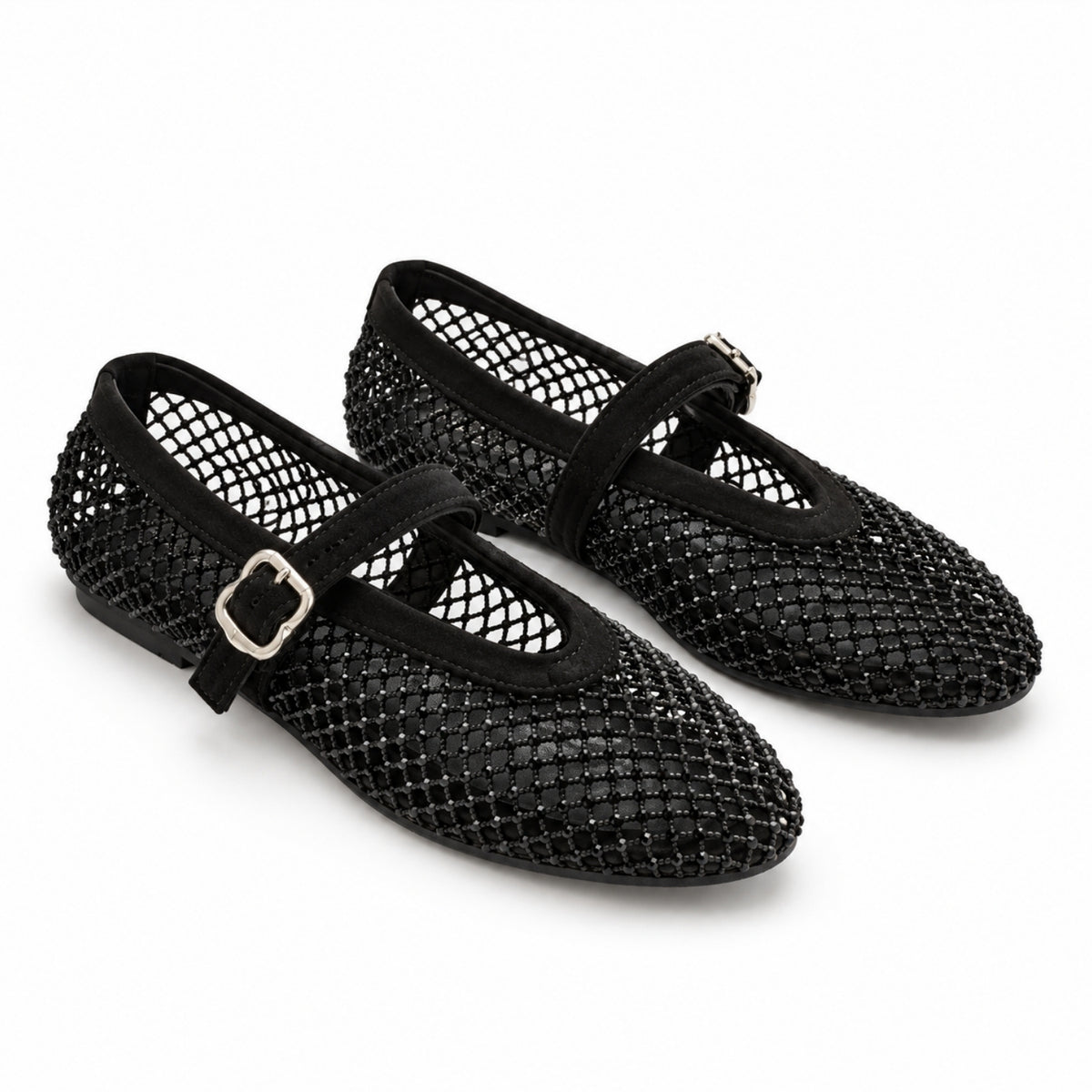 A pair of black open-mesh Mary Jane flats with black straps and silver buckle details, shown on a clean white background.
