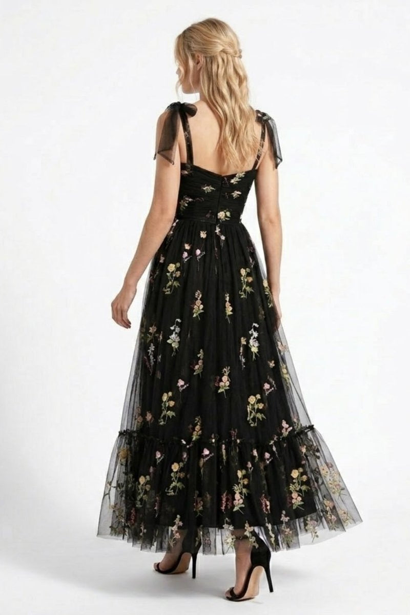 Back view of Fenlo Form black floral embroidered tulle maxi dress featuring concealed back zipper and sheer shoulder bows. 