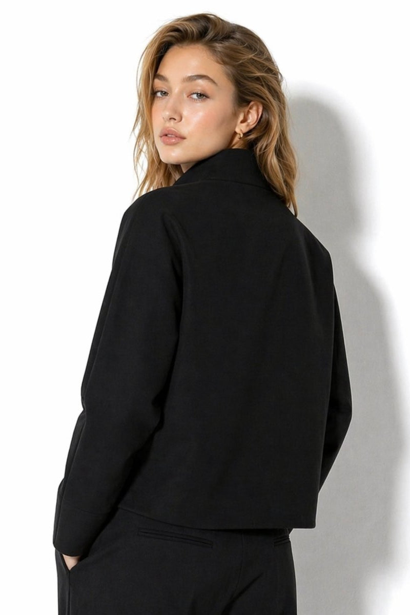 Back detail over the shoulder of the women's black long sleeve structured transitional outerwear jacket by Kouvr.