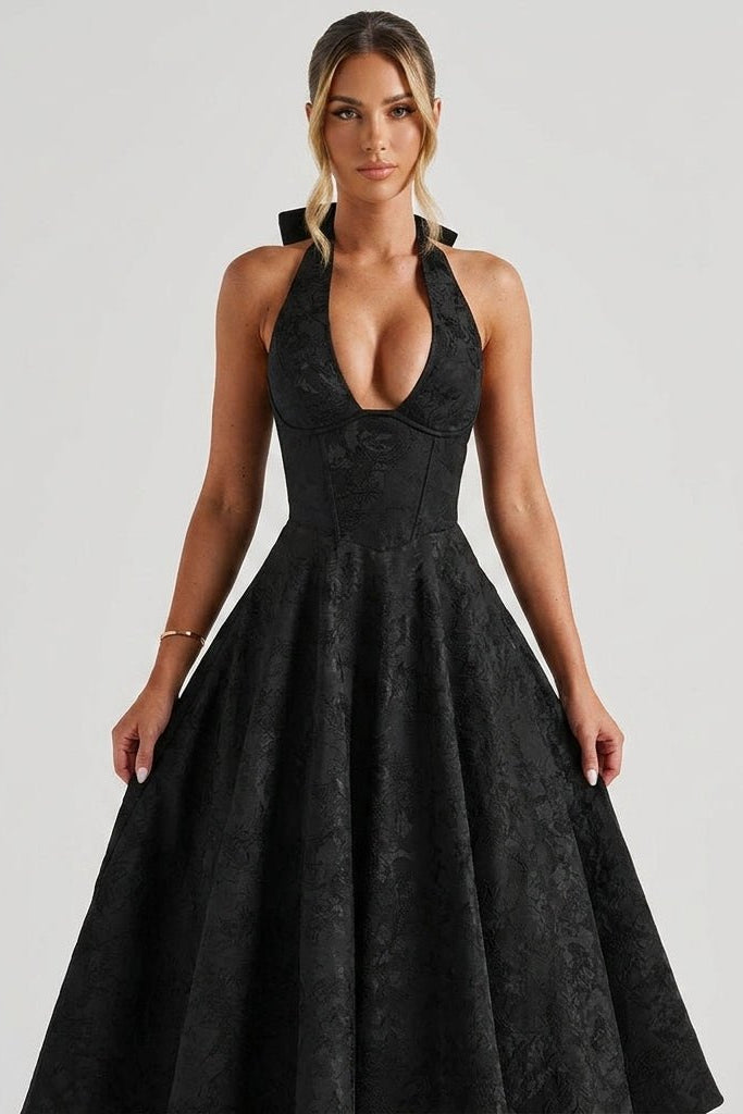 Close up of black brocade structured corset bodice with deep V-neckline on formal cocktail dress.