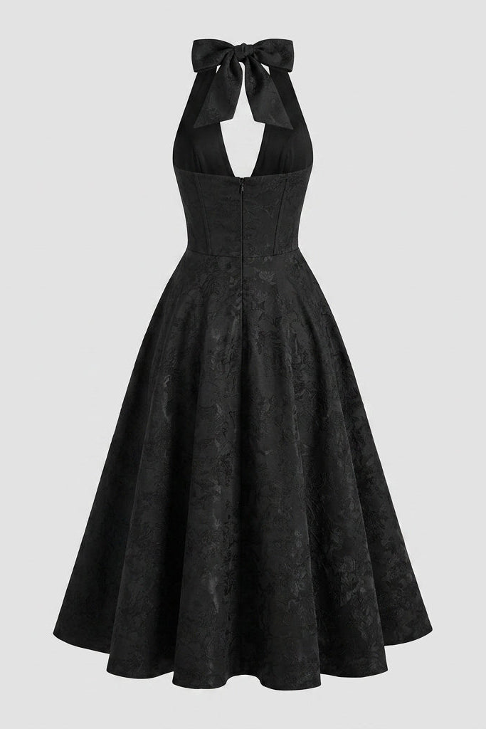 Back view of black formal midi dress showing invisible zipper and self-tie neck bow.