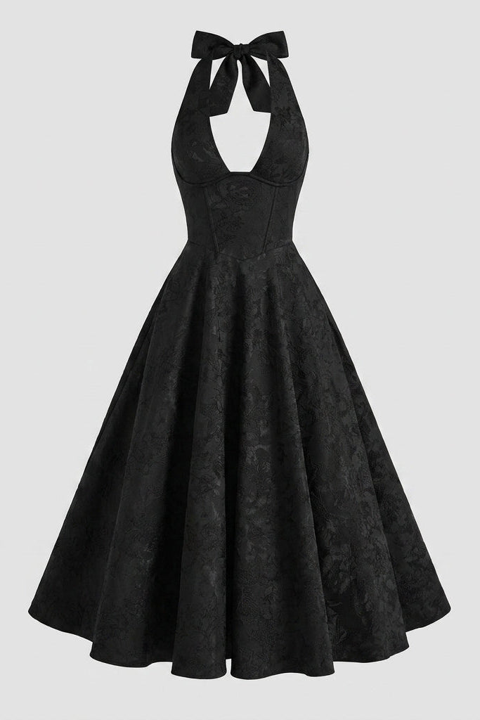 Front view of black A-line midi dress with halter neck and subtle floral woven pattern on white background.