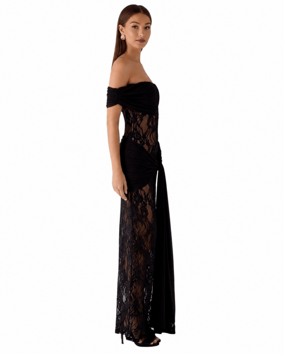 A woman modeling a black off-the-shoulder lace maxi dress with a fitted bodice and flowing skirt, shown against a plain white background.