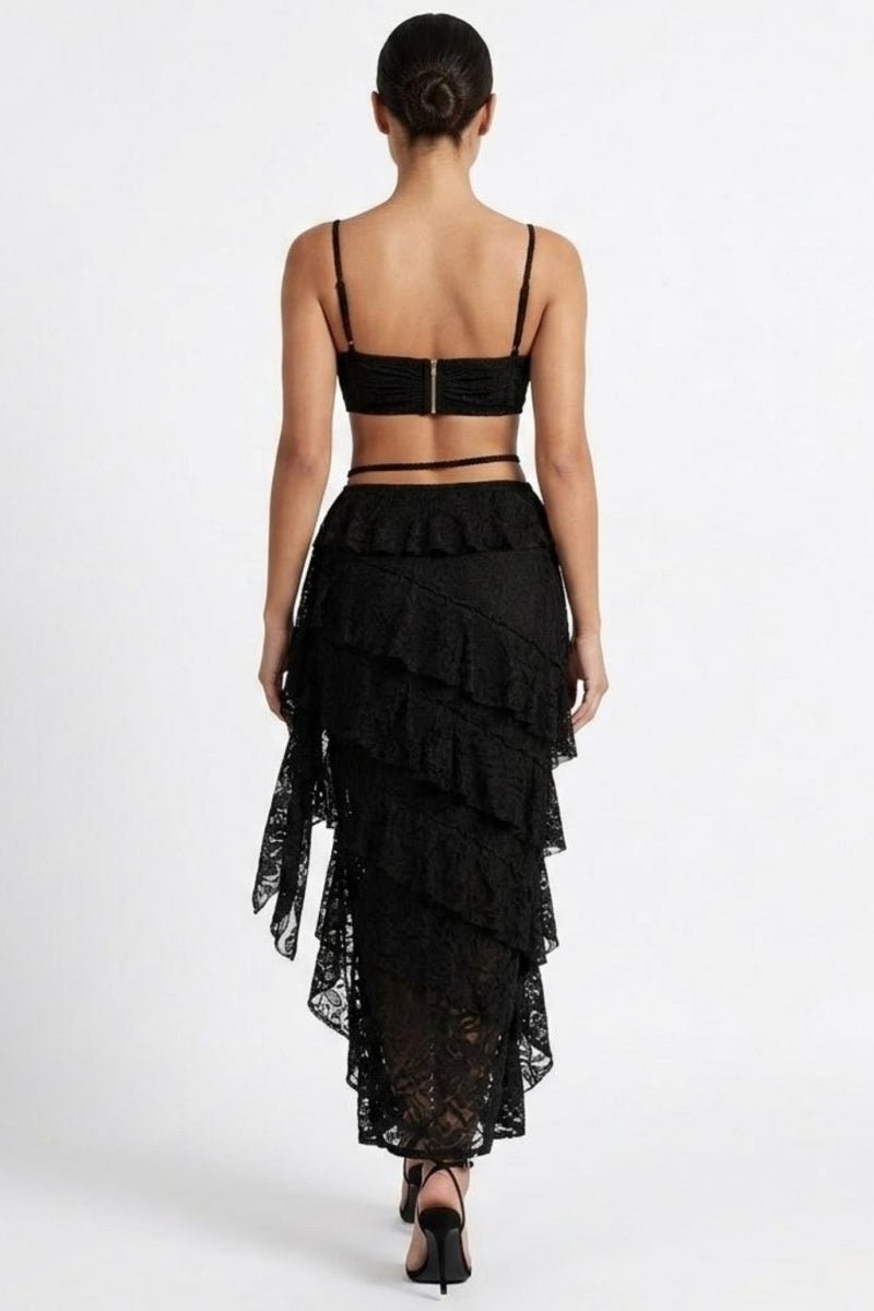 Black lace dress with ruffled layers on a white background