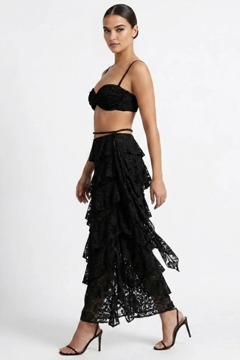 Woman wearing a black lace outfit on a white background