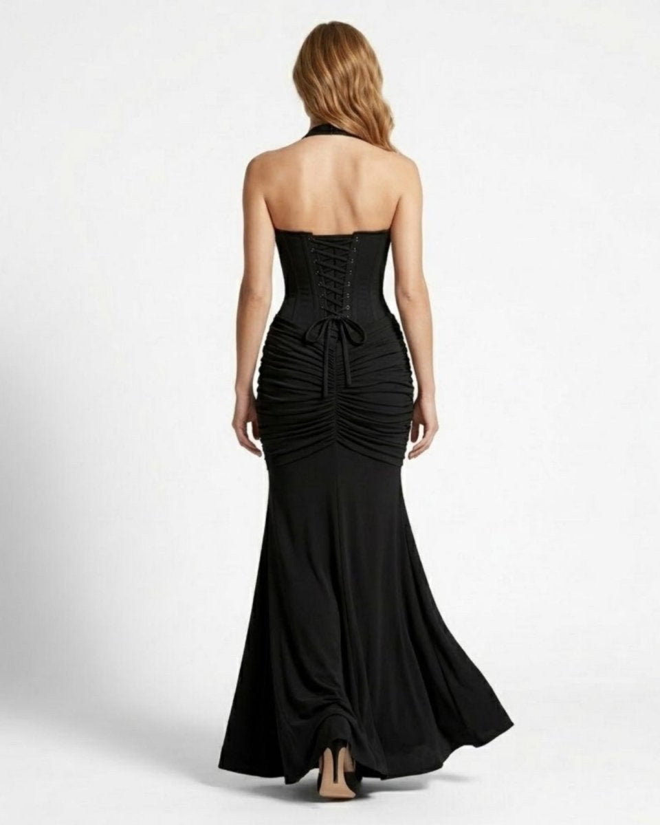 Back view of a sophisticated black formal maxi dress featuring a structured lace-up corset back tie and flowing train.