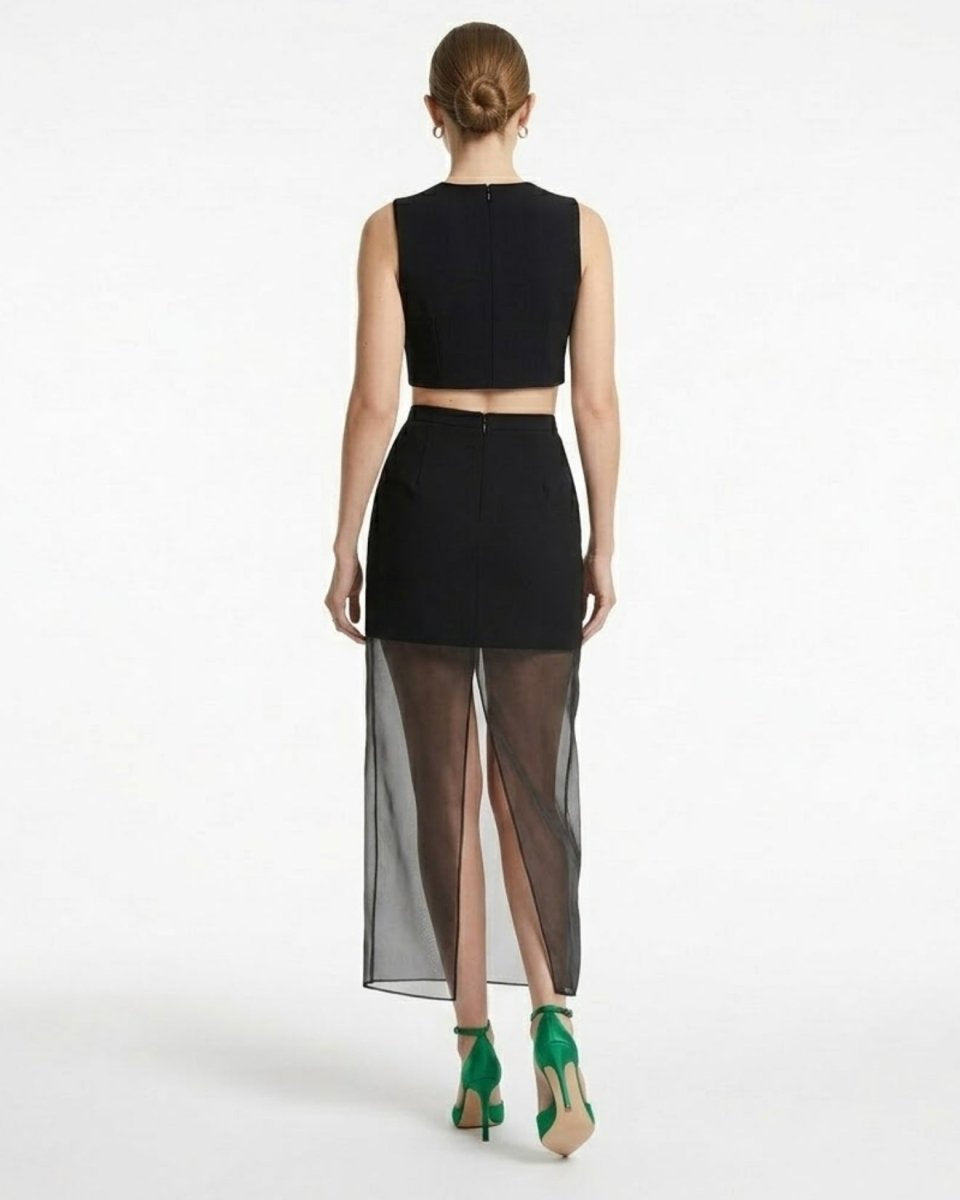 Back view of black high waisted evening skirt showing invisible zipper and sheer back slit detail for easy movement 