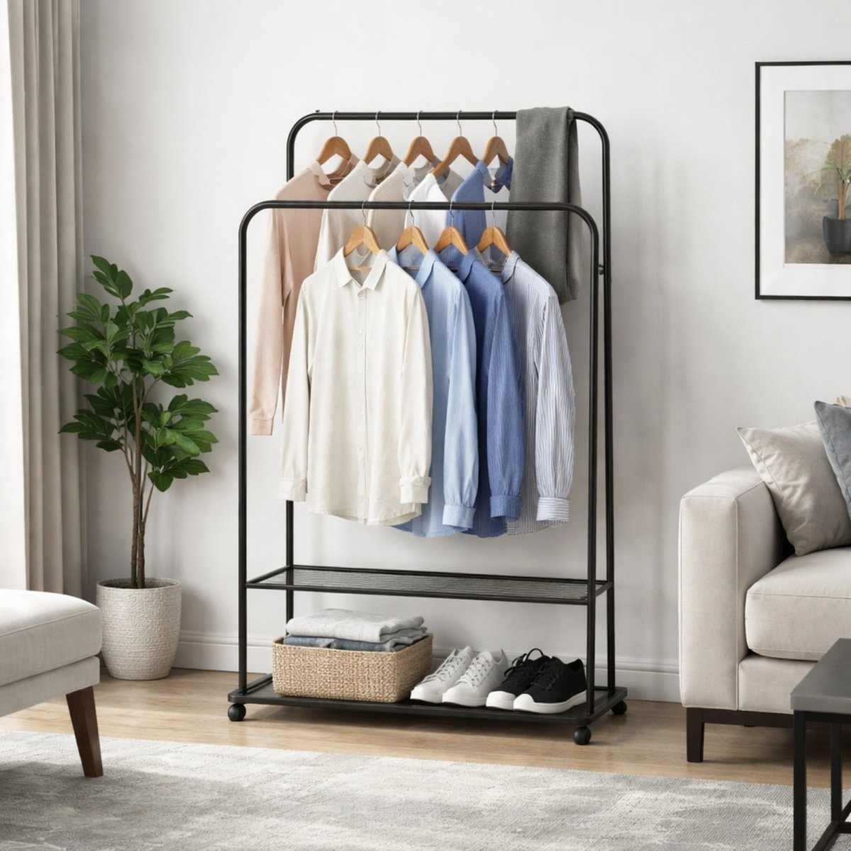 A fully styled black metal clothes rack with shirts on two tiers, and a basket of folded clothes and sneakers on the wire mesh shelves in a modern living space.