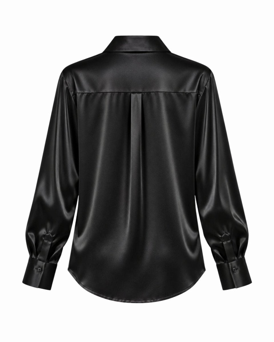 A black silk long-sleeve blouse shown from the back, featuring a center back pleat and buttoned cuffs, displayed on a solid white background.