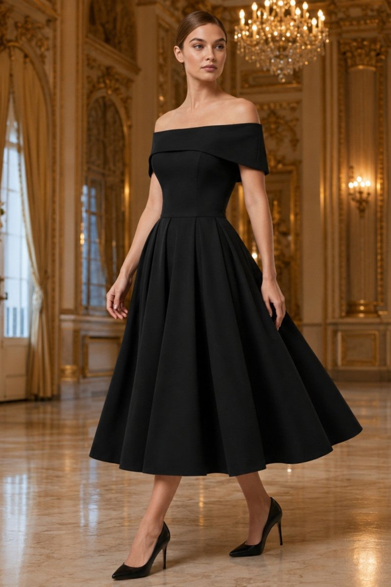 A woman models an off-the-shoulder black midi dress with a structured bodice and a full flared skirt, paired with black heels, set against an ornate golden chandelier-lined ballroom.