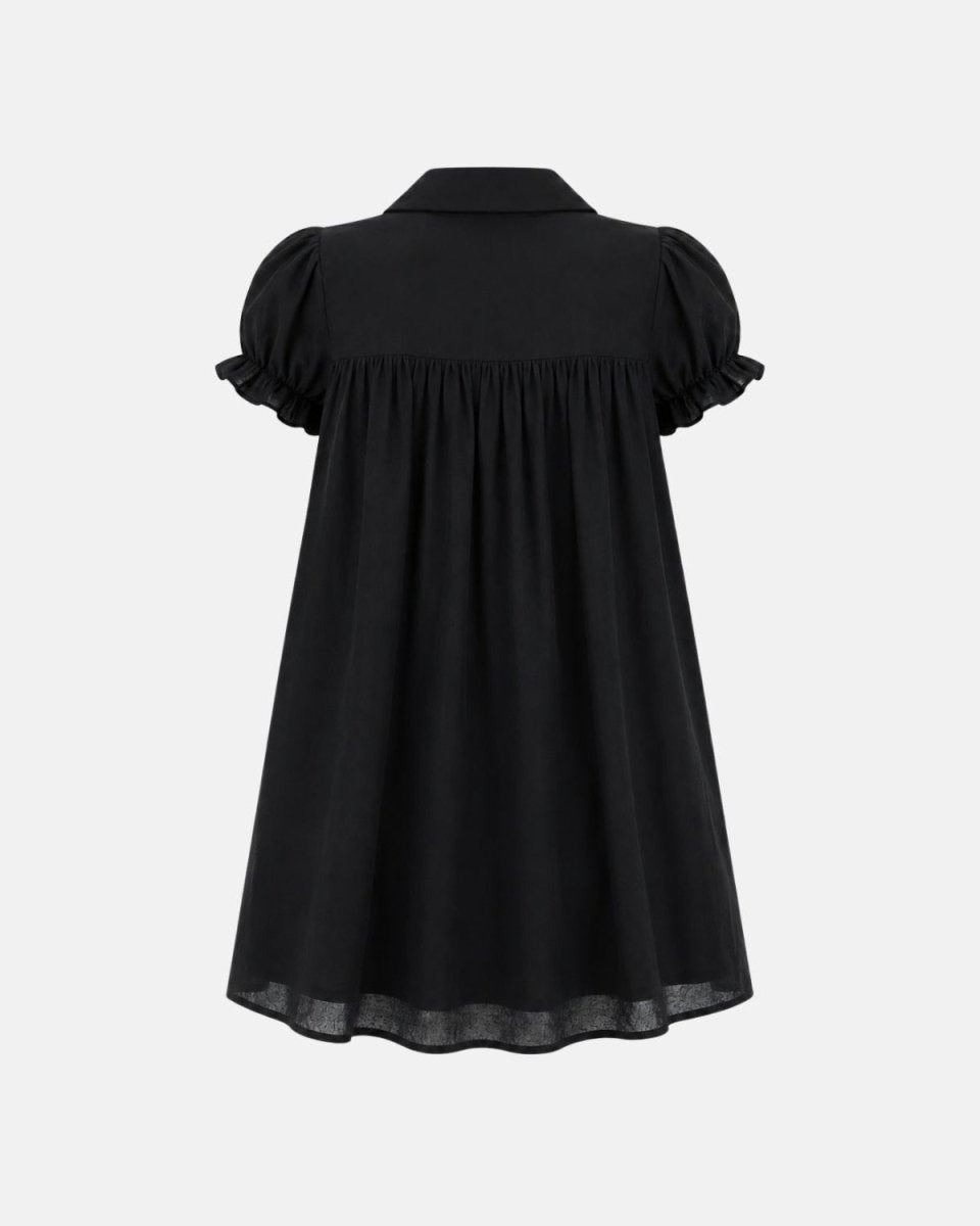 A black short-sleeve blouse shown from the back, featuring puffed sleeves with ruffled edges, a defined waist seam, and a slightly sheer hem, displayed against a light gray background.