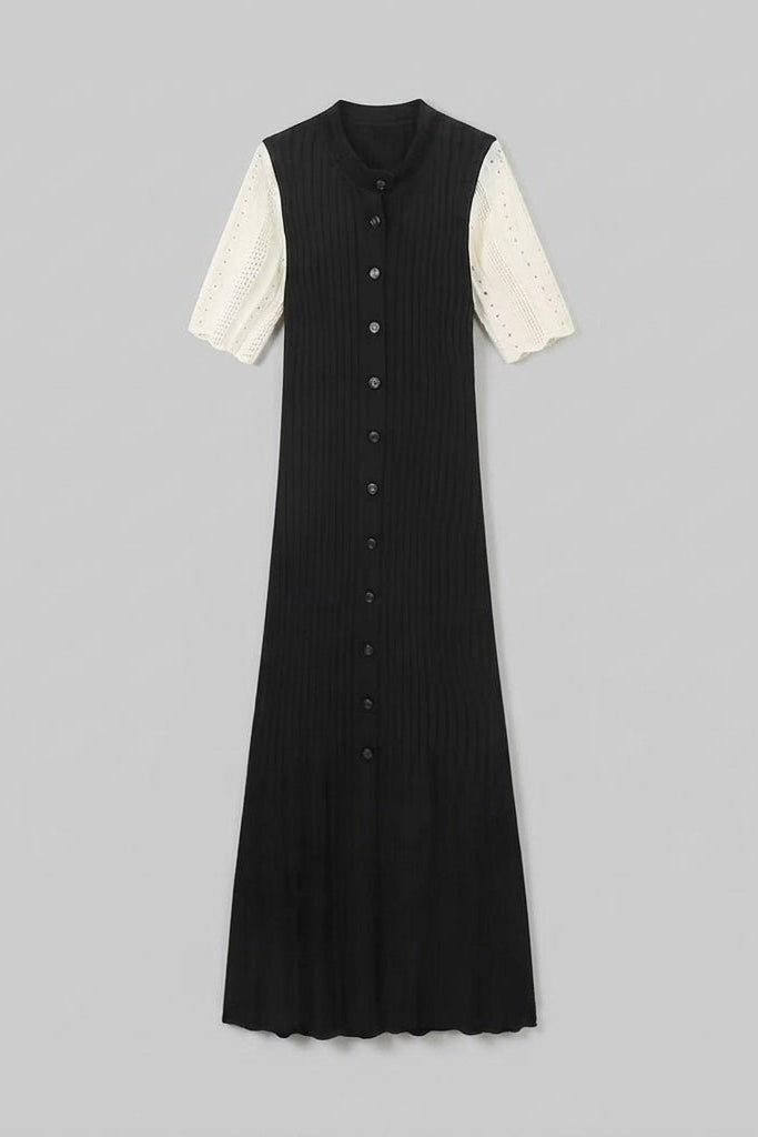 Flat lay front view of the Fenlo Form black ribbed knit button-down maxi dress with cream short sleeves on a grey background.