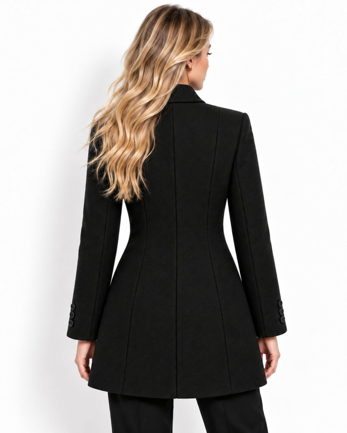 A woman shown from the back wearing a structured black blazer with structured shoulders, long sleeves, and button details on the cuffs, paired with black pants against a plain white background.