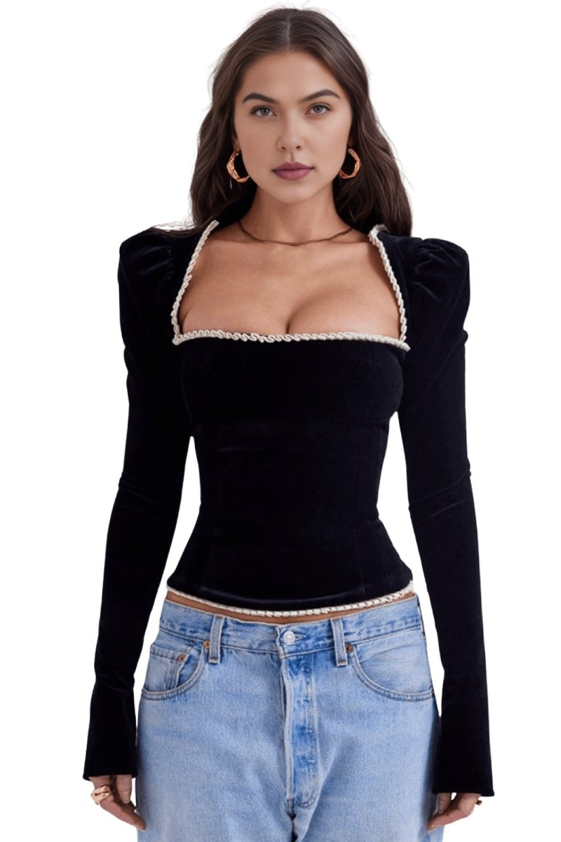 Fenlo Form woman wearing a black long-sleeve top with lace trim and blue jeans on a white background