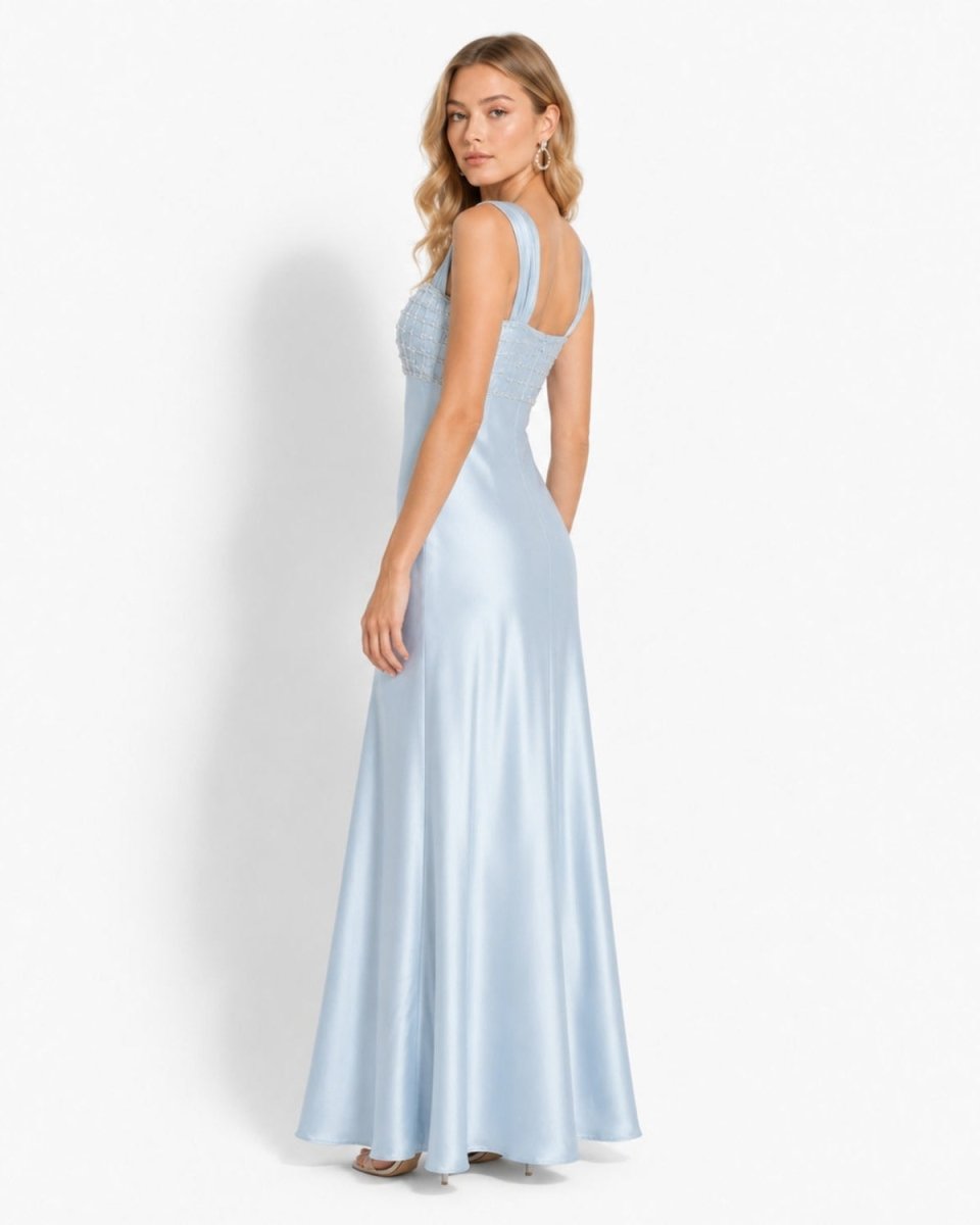 Side angle of ice blue luxury satin maxi dress highlighting the flowing drape and wide ruched shoulder straps