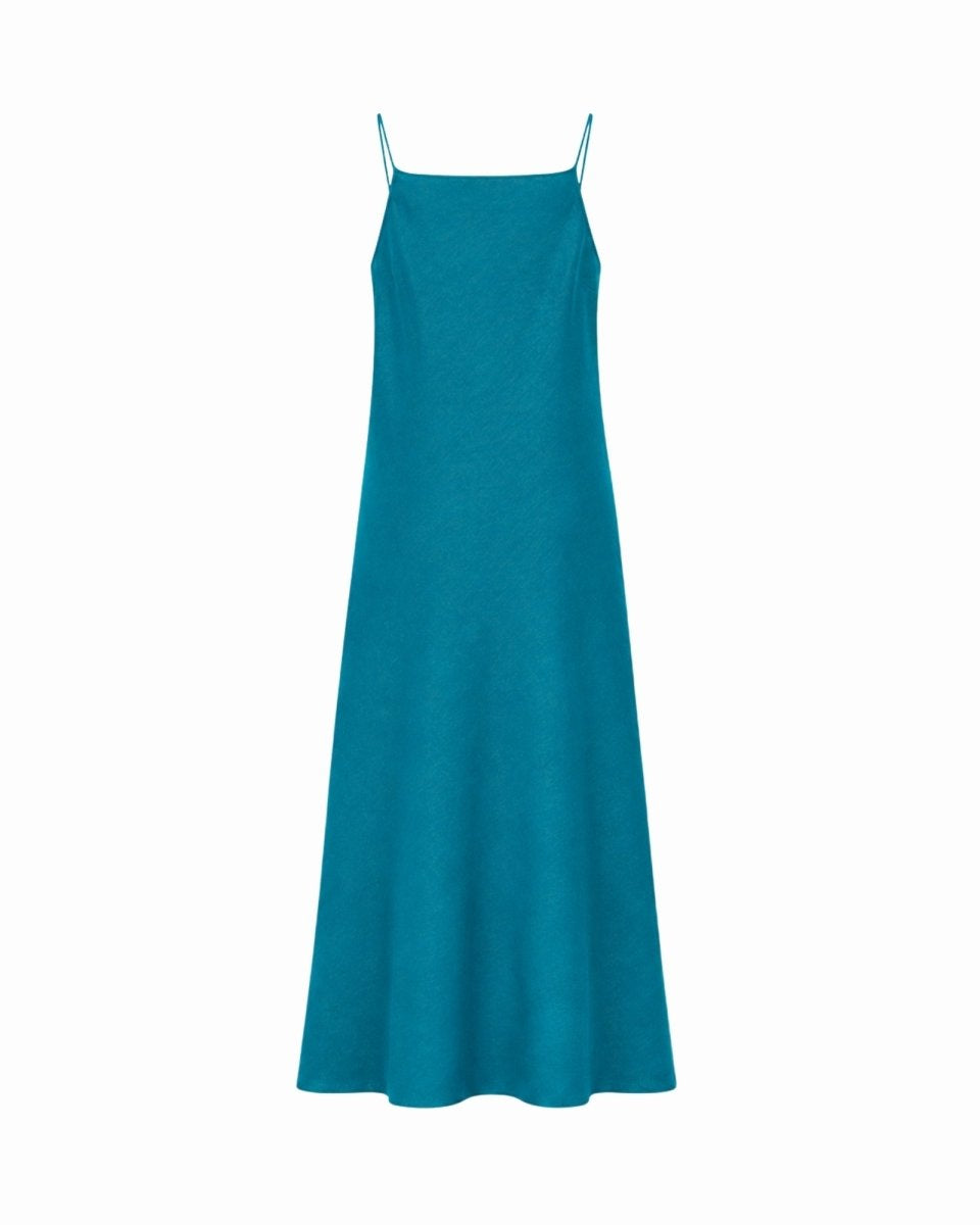 Back view of the solid teal midi slip dress showcasing the fluid a-line skirt silhouette and thin straps.