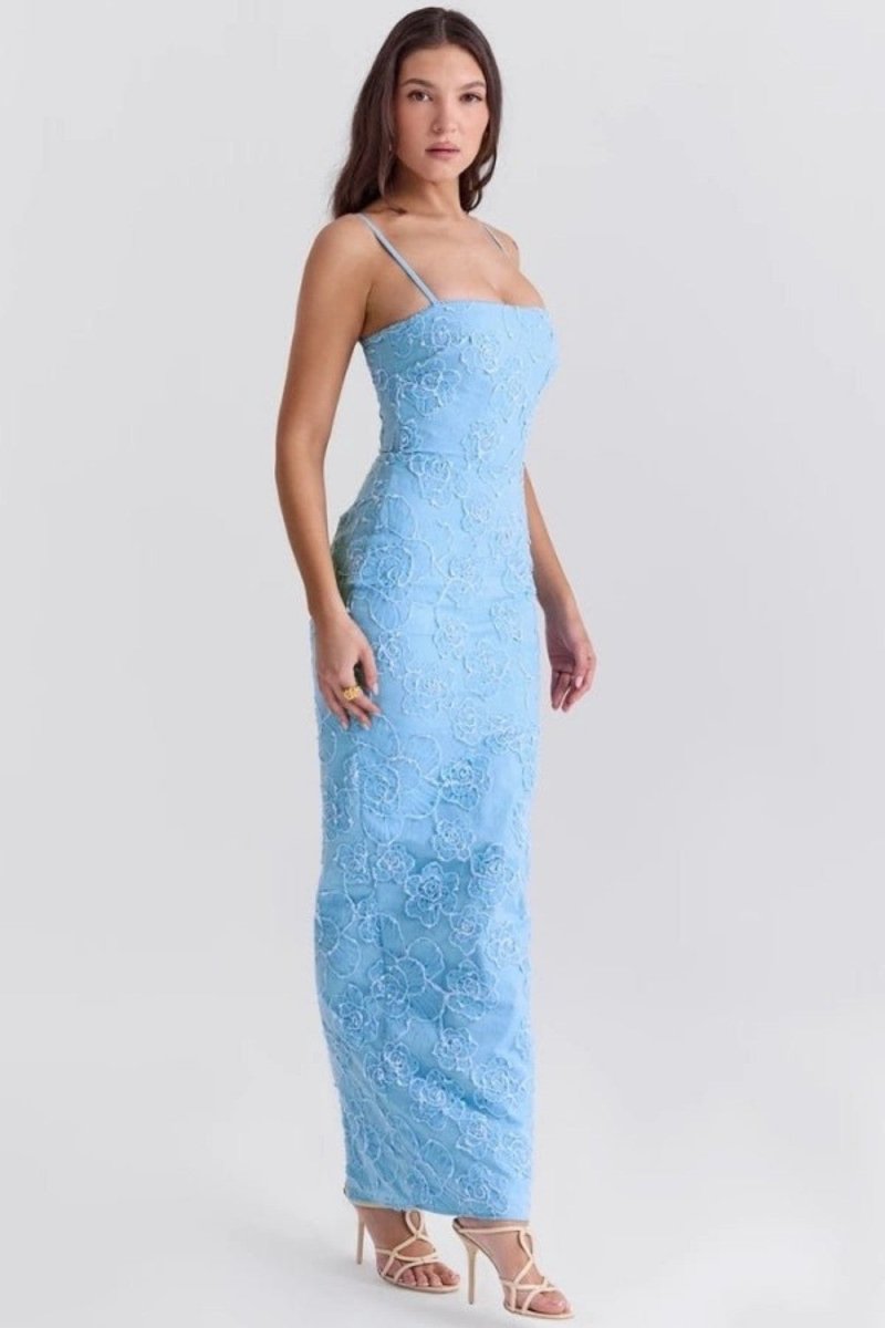Woman wearing a light blue lace dress on a white background