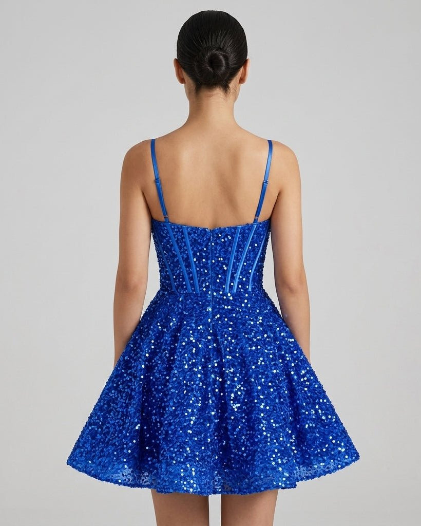 Back view of royal blue sequin skater dress showing hidden zip closure and thin adjustable straps.