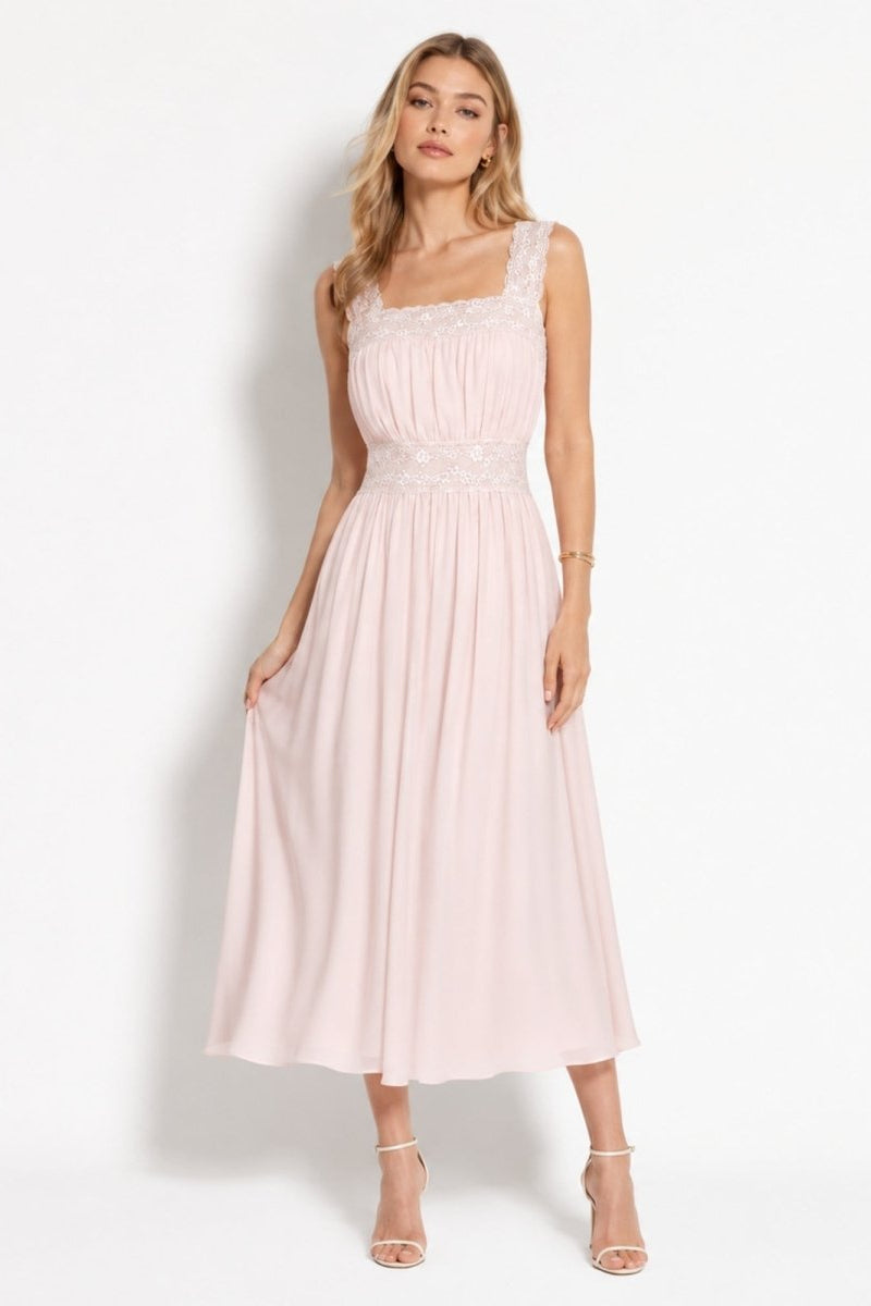 Woman wearing Kouvr blush pink lace trim square neck pleated chiffon midi dress standing gracefully