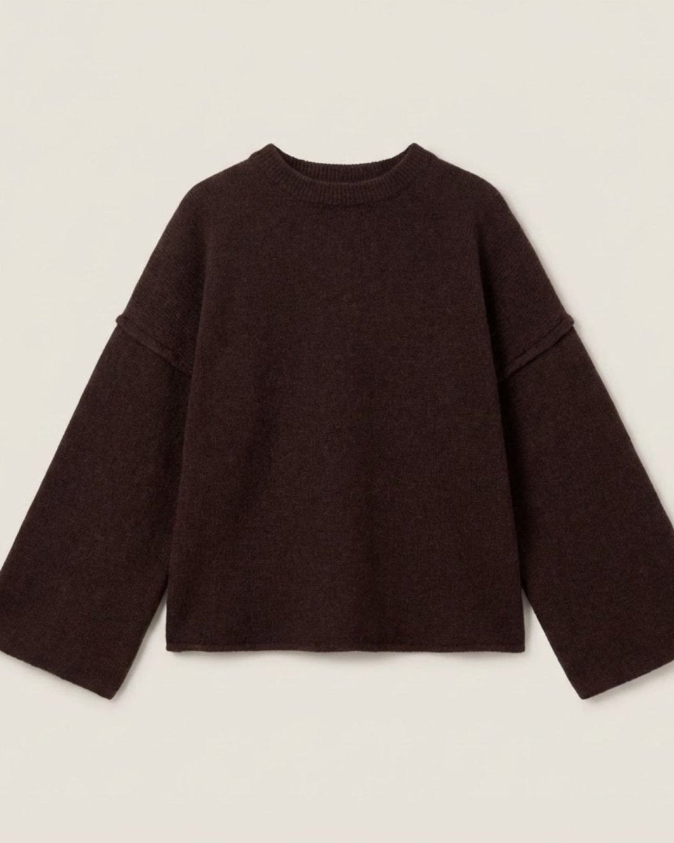 Flat lay of the oversized dark brown sweater showcasing its wide sleeves and crewneck.