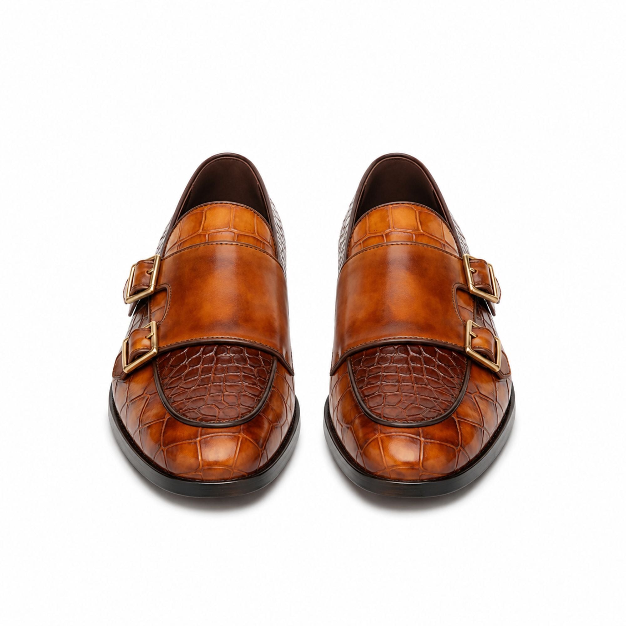 A pair of men's double-strap loafers in brown leather, featuring a smooth upper strap, an embossed crocodile-pattern toe cap, and gold-tone buckle details, shown from a top-down view on a white background.