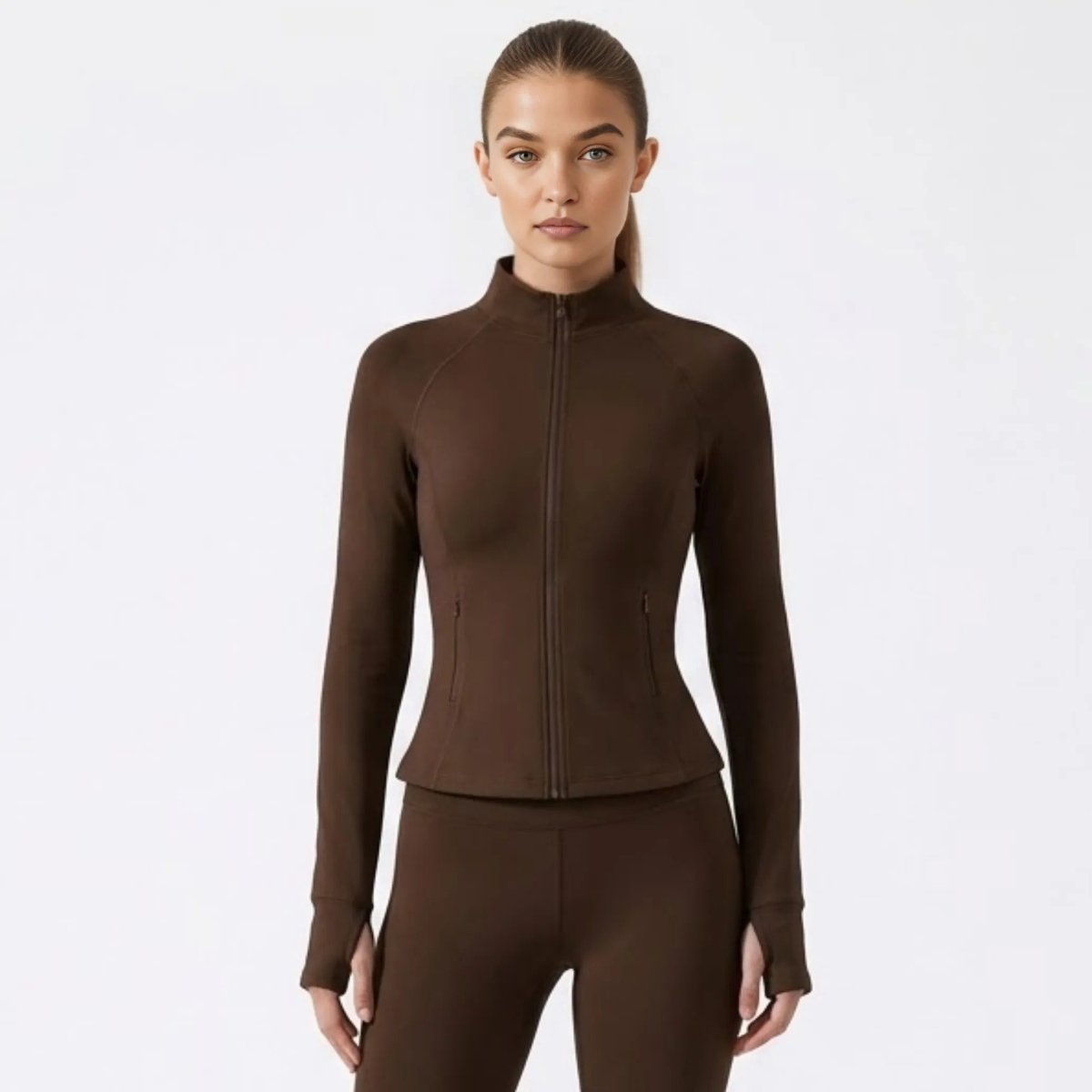 Front view of woman wearing  brown fitted zip-up activewear jacket by Kouvr