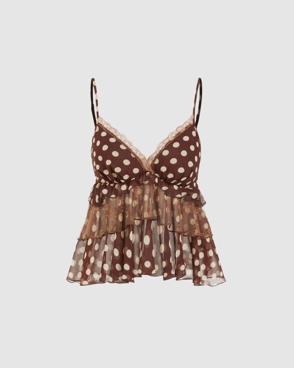A brown and beige polka-dot camisole top with thin straps, a lace-trimmed V-neckline, and a ruffled tiered hem, shown against a solid light gray background.