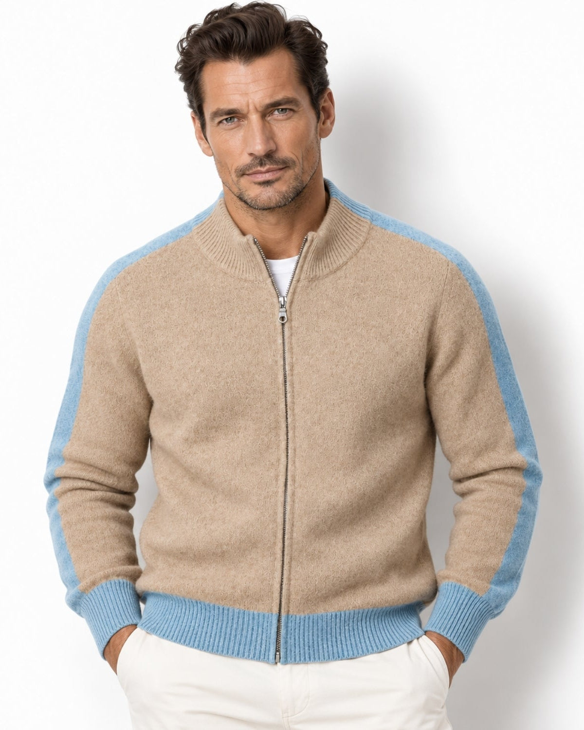 Front view of a man modeling the luxury camel and light blue contrast stripe full zip knit sweater jacket over a white t-shirt
