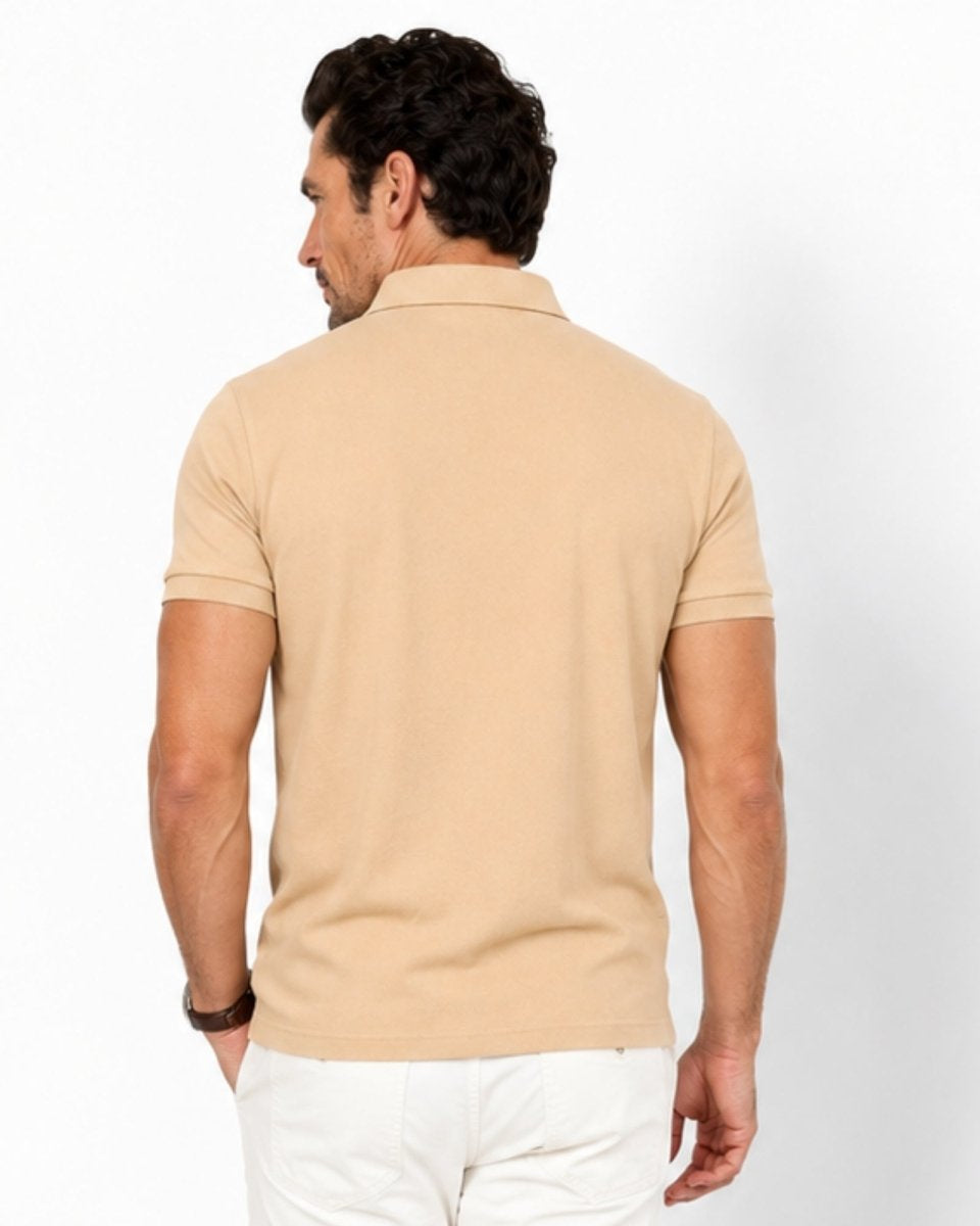 Man wearing a beige polo shirt on a white background