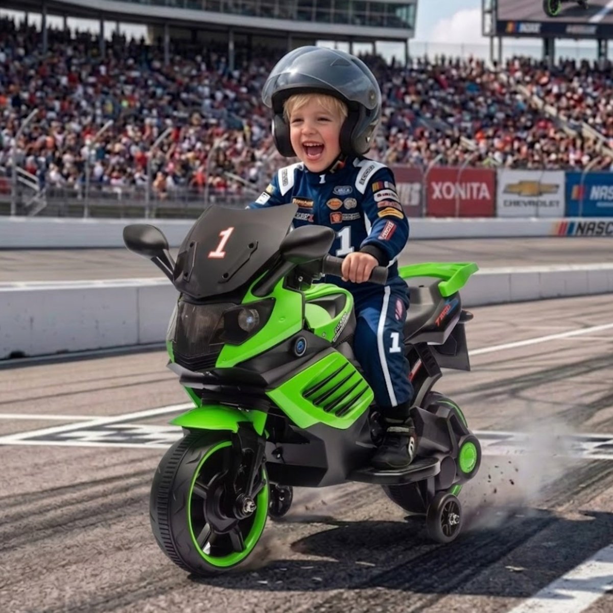 A happy young boy with blonde hair wearing a dark helmet and racing gear, riding a bright green and black electric toy motorcycle on a racetrack with crowds in the background.