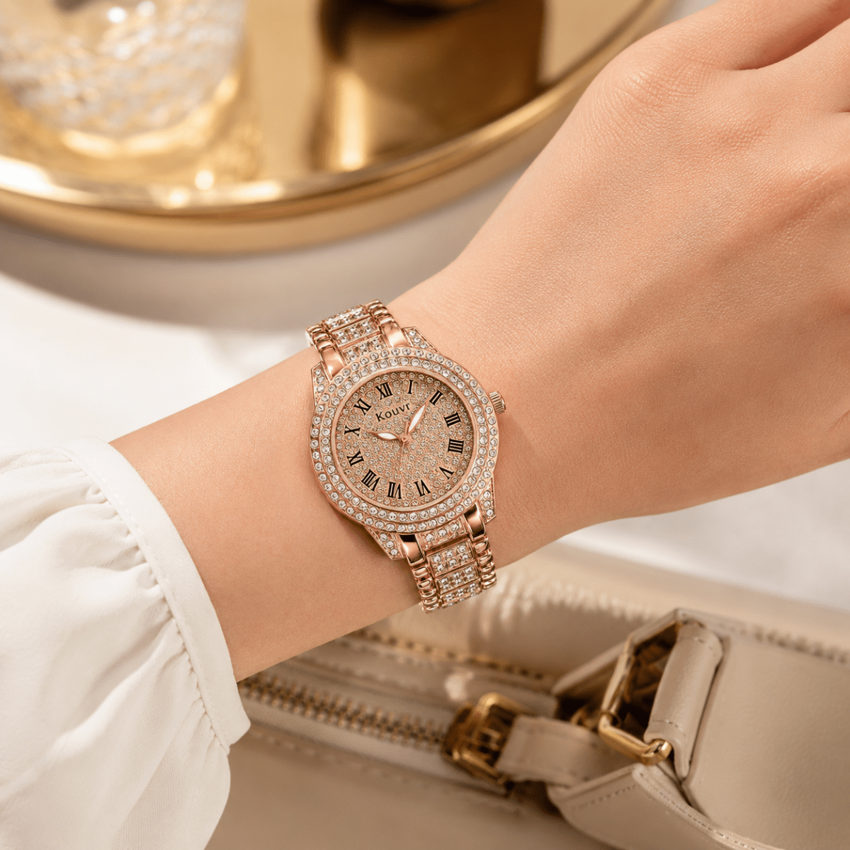 Close up detail of a woman's wrist wearing an elegant rose gold luxury watch with a sparkling diamond-style face and metallic link bracelet.
