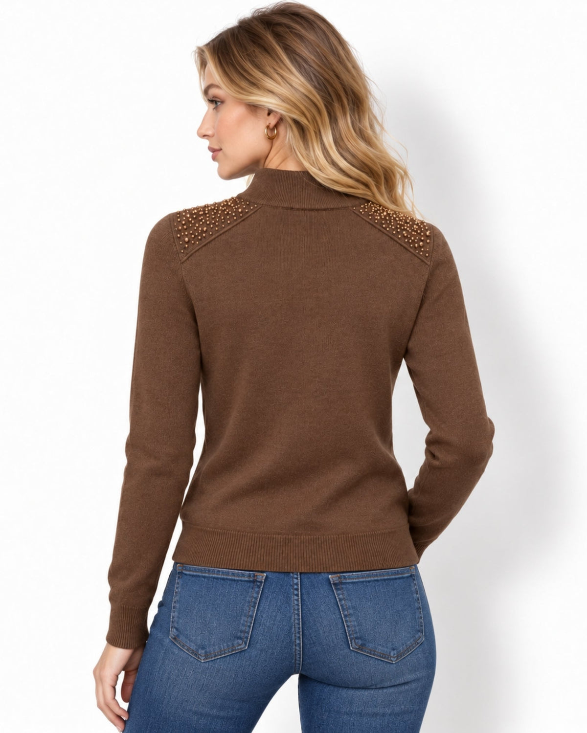 A woman shown from the back wearing a brown mock-neck knit sweater with textured beaded shoulder details, paired with blue jeans, against a plain white background.