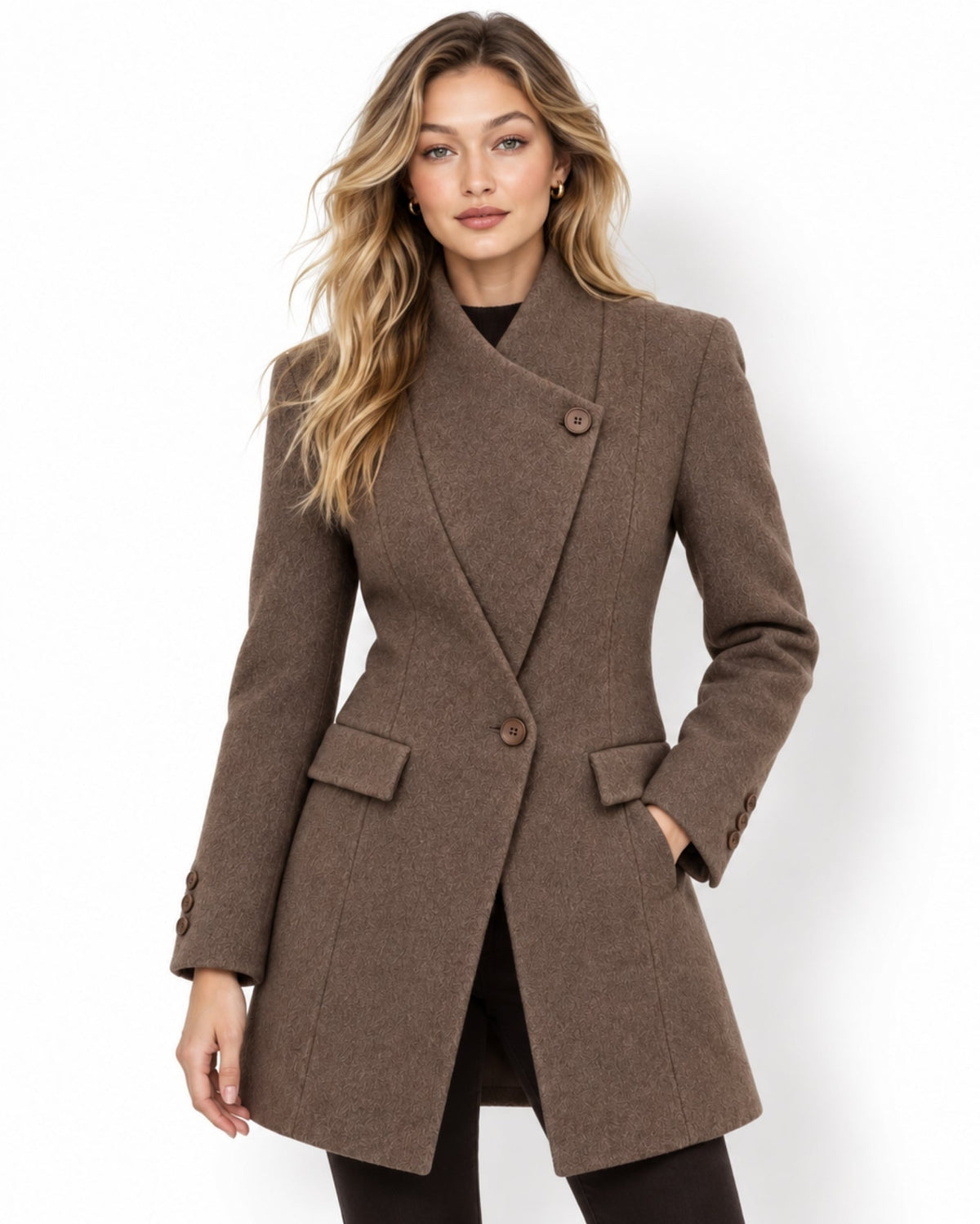 A woman modeling a brown double-breasted wrap coat with a shawl collar, notched lapels, and two front buttons, photographed against a clean white studio background.