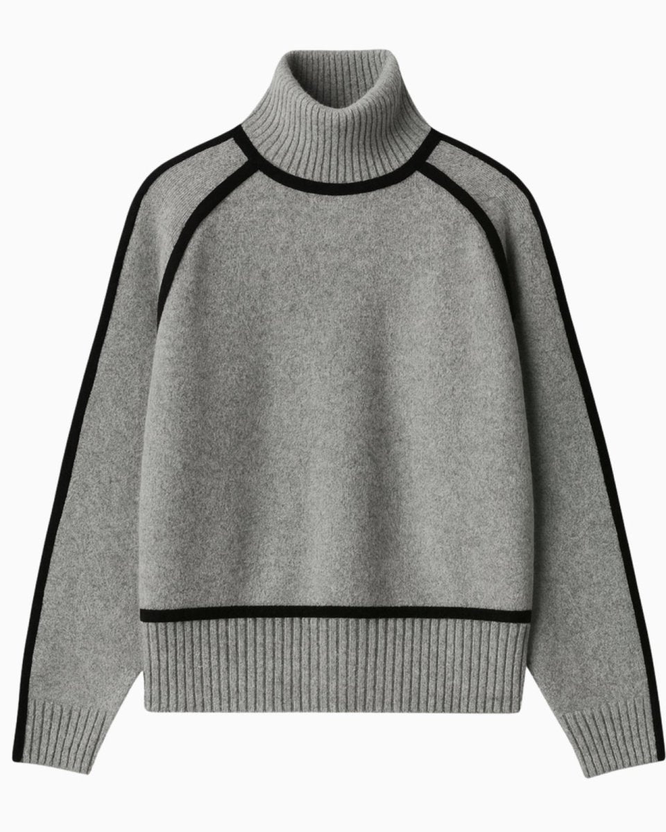 Flatlay of a gray turtleneck sweater with black piping detail, showing the ribbed hem and cuffs.