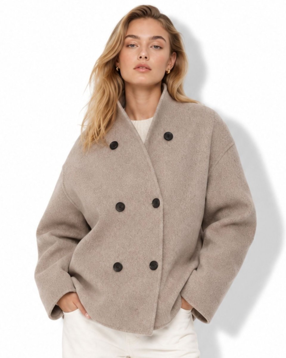 Woman modeling the oversized wool short coat featuring double breasted buttons and a funnel neck collar