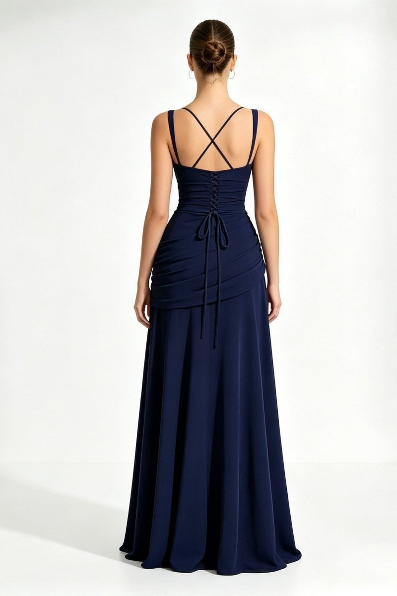Back view of a dark blue formal dress showcasing an adjustable strappy lace-up corset back and elegant trailing gown fabric.