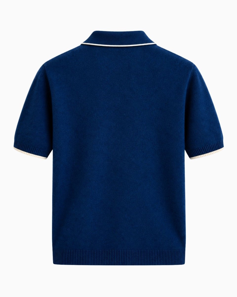 A navy blue short-sleeve knit polo shirt shown from the back, featuring white contrast piping along the collar and sleeve cuffs, set against a plain white background.