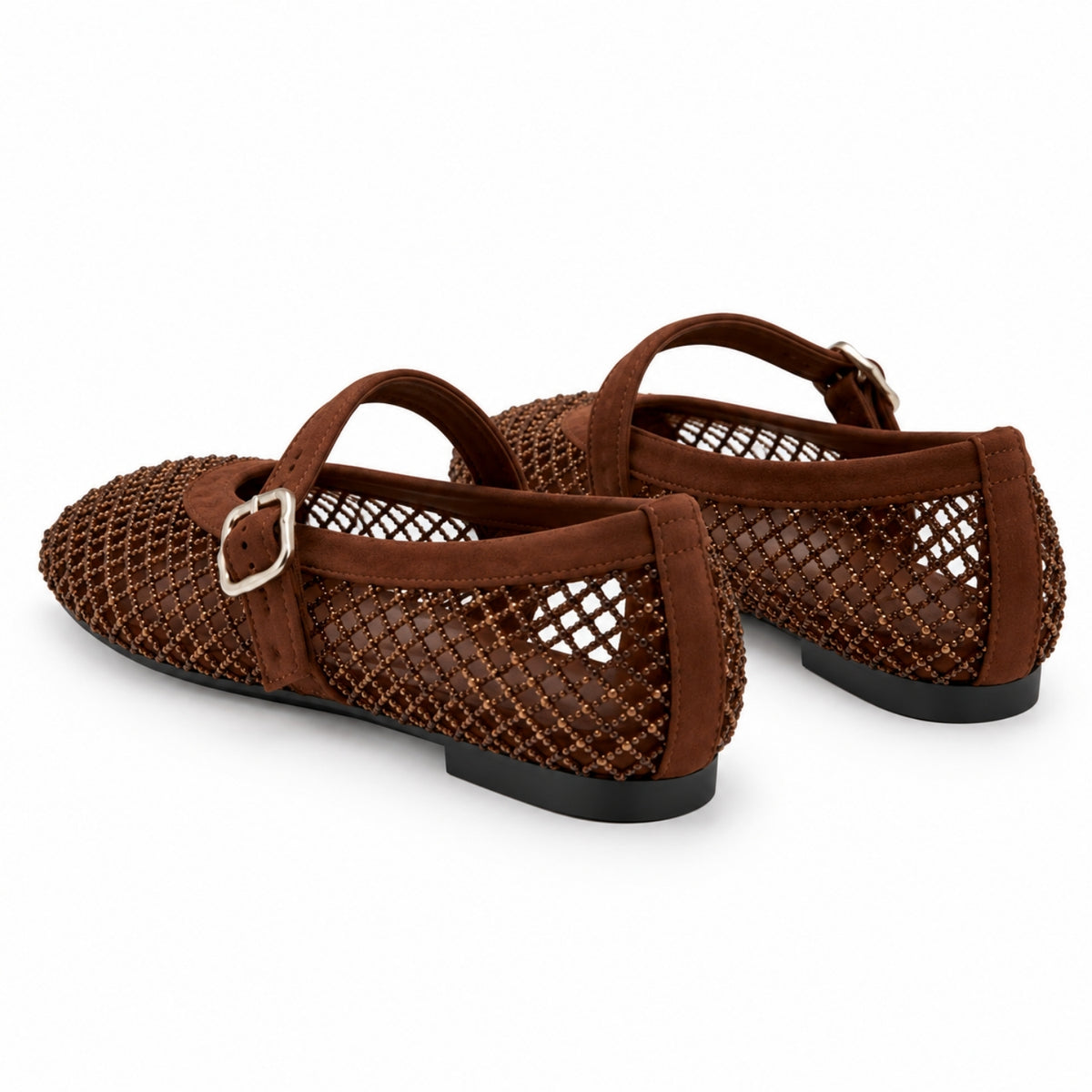 A pair of women's Mary Jane flats in brown, featuring a textured openwork upper with a small silver buckle on the strap, shown against a plain white background.