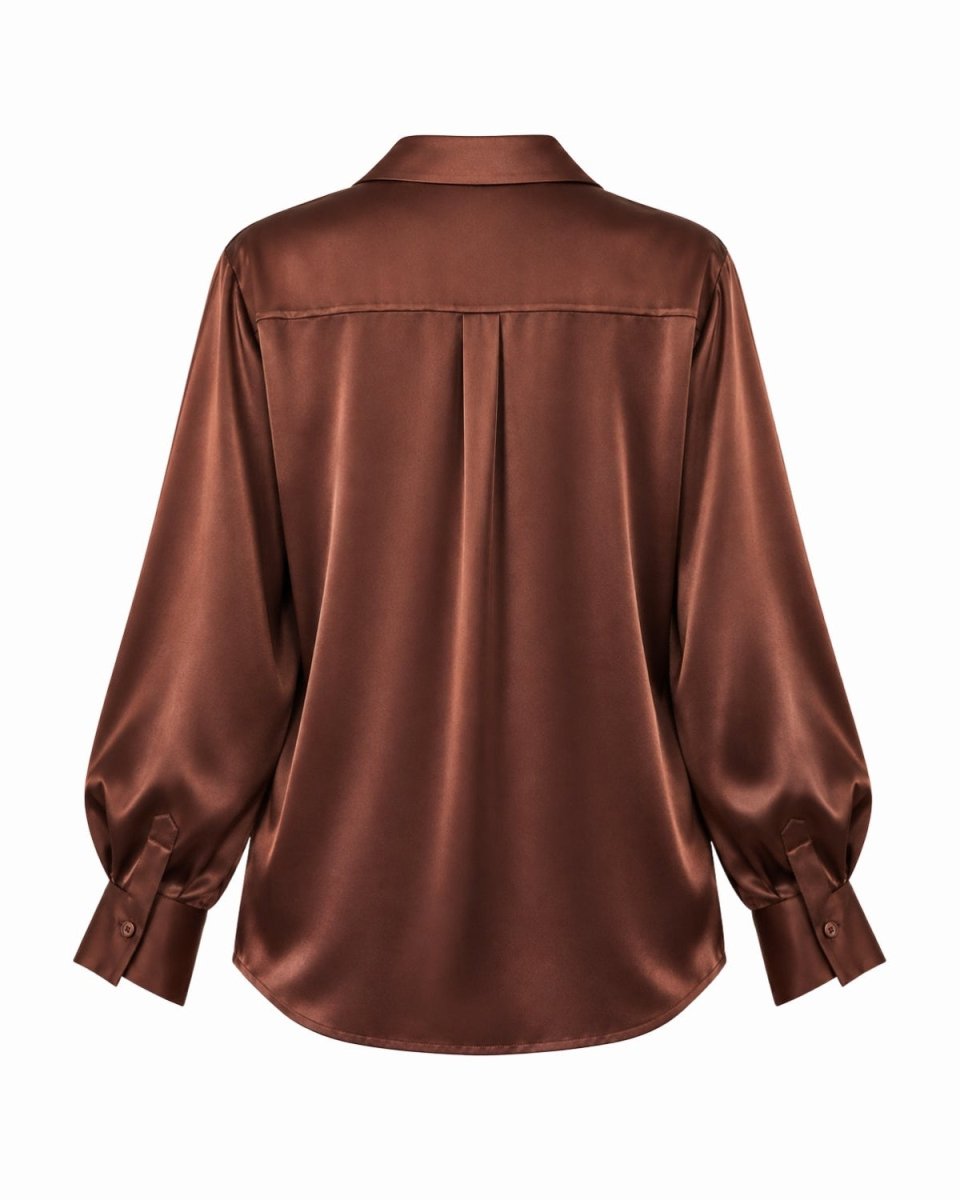 A brown silk long-sleeve button-up shirt shown from the back, featuring a subtle sheen and a small pleated detail at the upper back, set against a plain white background.