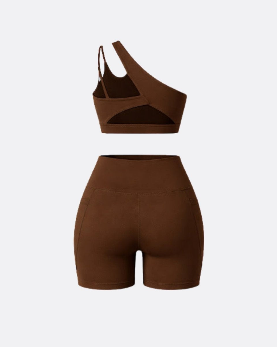 Flat lay back view of dark brown strappy sports bra and high waisted athletic shorts