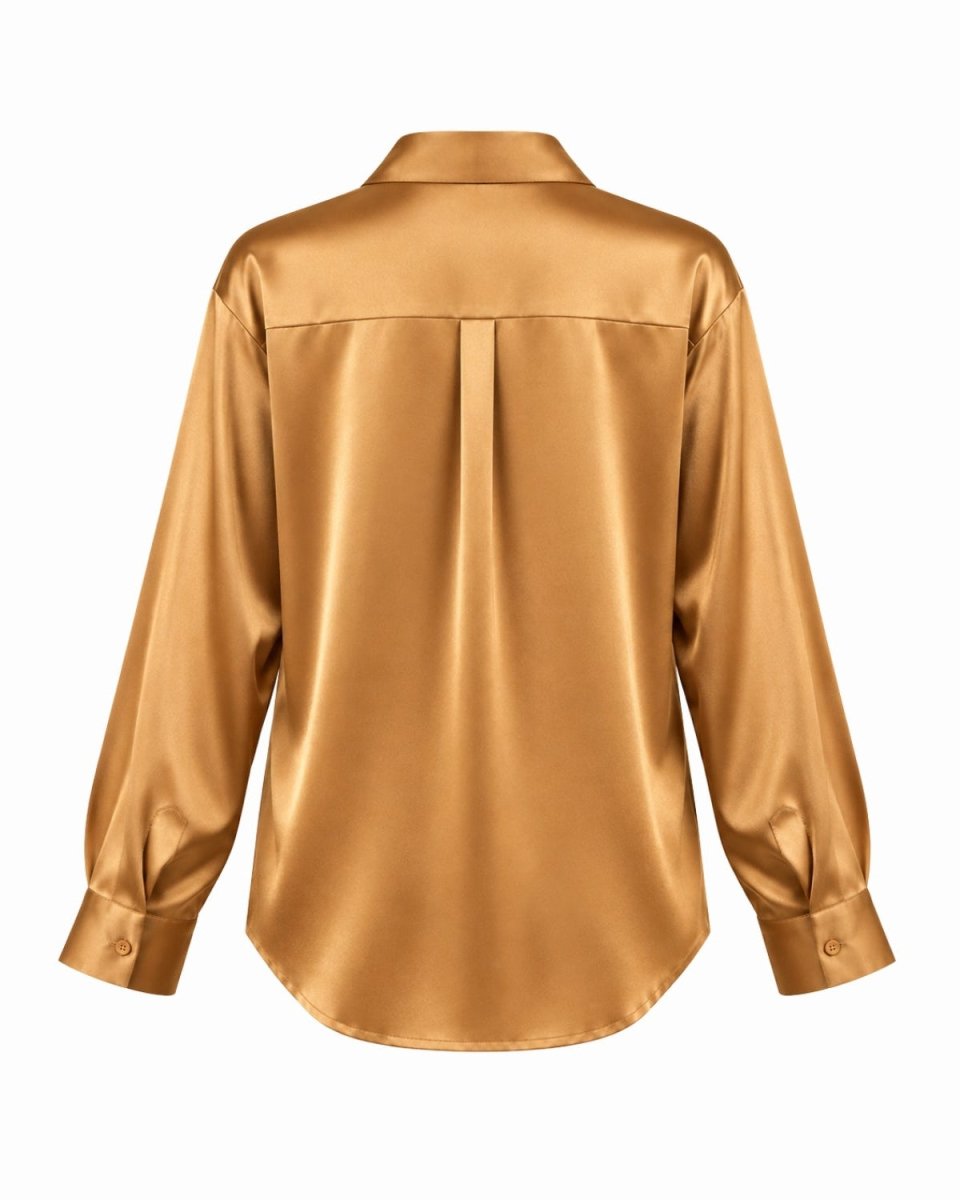 A long-sleeve silk blouse shown from the back, featuring a subtle vertical pleat down the center back, a collar, and buttoned cuffs, in a warm metallic gold color.