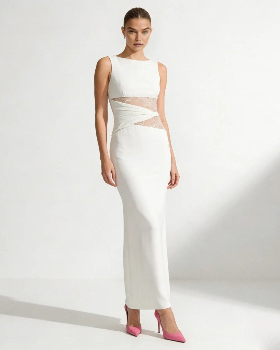 Model wearing the Deborah oversized white sweater with wide sleeves, paired with black pants, against a white background.
