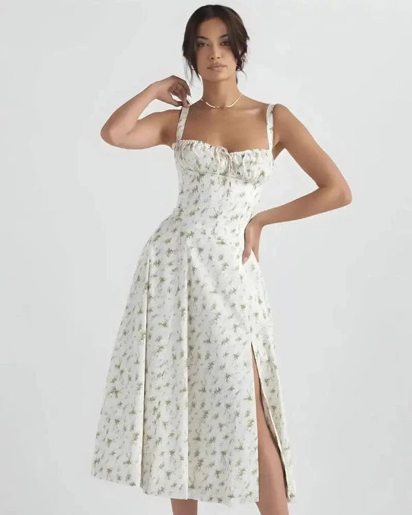 Woman wearing a floral dress with a slit on a white background