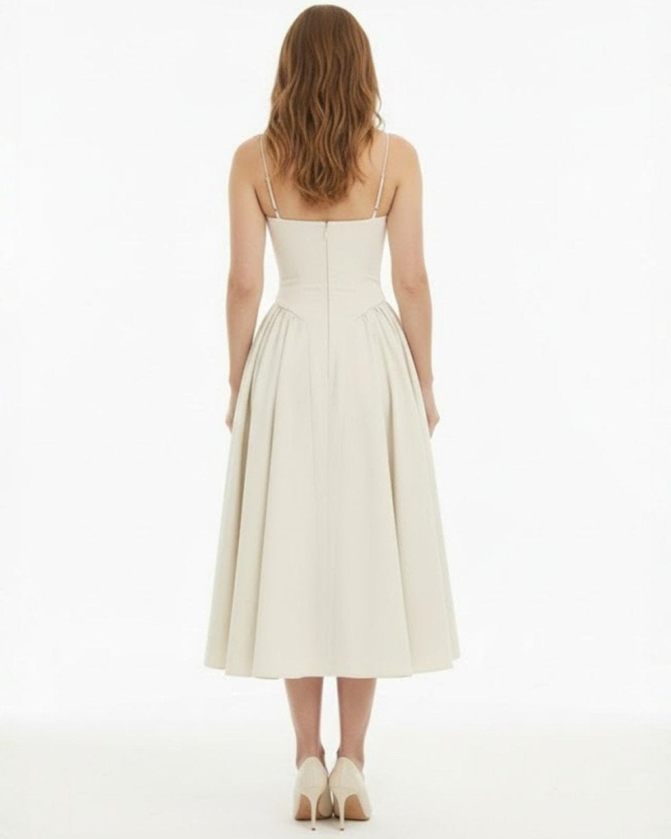 Back view of the ecru corset midi dress with spaghetti straps and invisible zipper closure.
