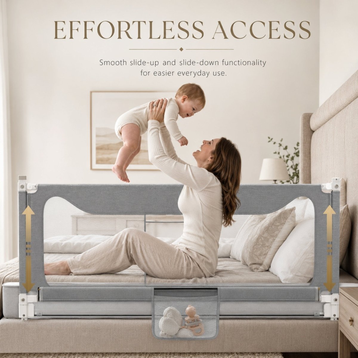 A mother happily lifting her baby over a lowered Kouvr vertical slide-down bed rail guard, demonstrating smooth bedside accessibility and a practical mesh storage pocket at the base.