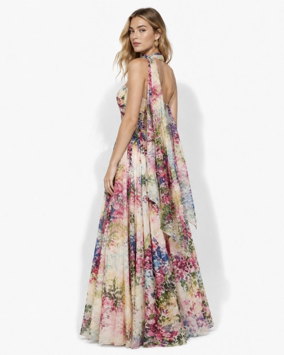 Side and back angle of the elegant floral evening dress showing the dramatic trailing chiffon scarf and open back design for summer galas.
