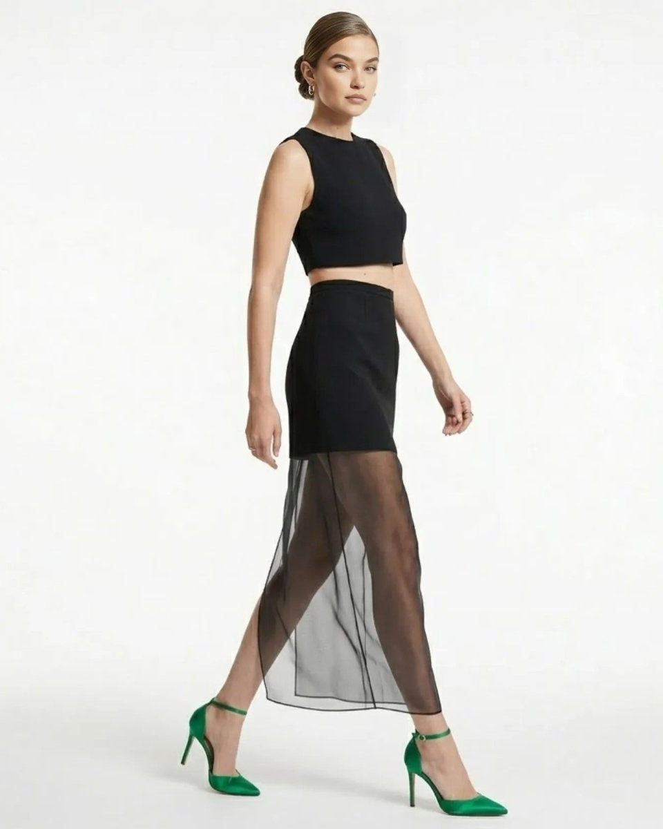 Side profile of fashion model walking in black semi-sheer evening skirt by showing garment movement and drape