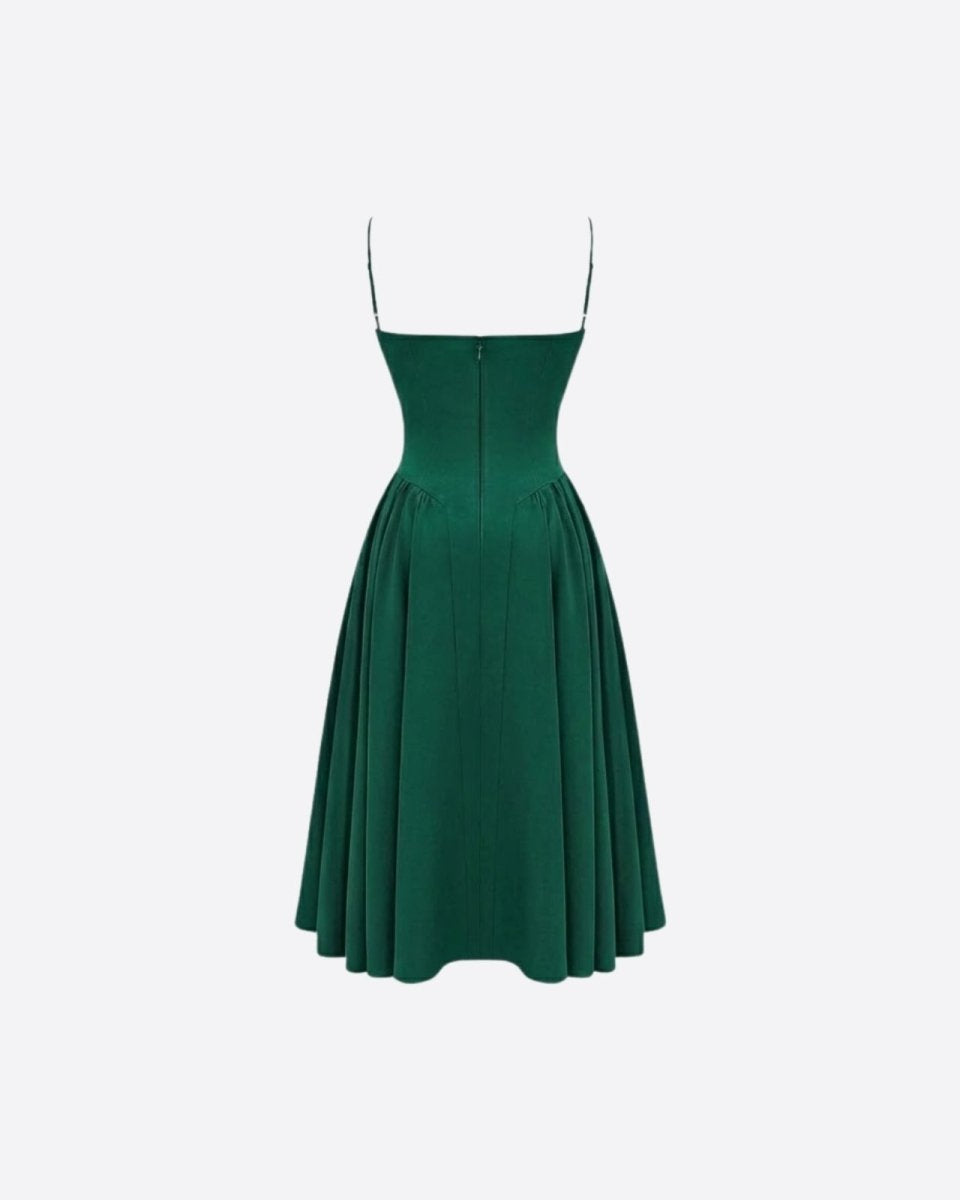Studio product shot of the back of an emerald green spaghetti strap midi dress, showing the zipper and fitted bodice construction.